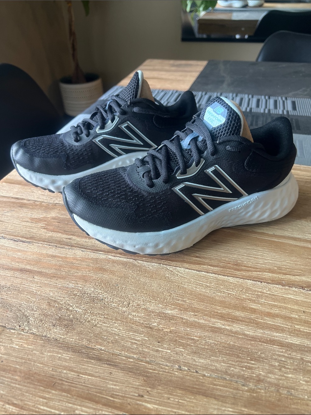 New Balance women’s Black and White Foam Runner Sneakers